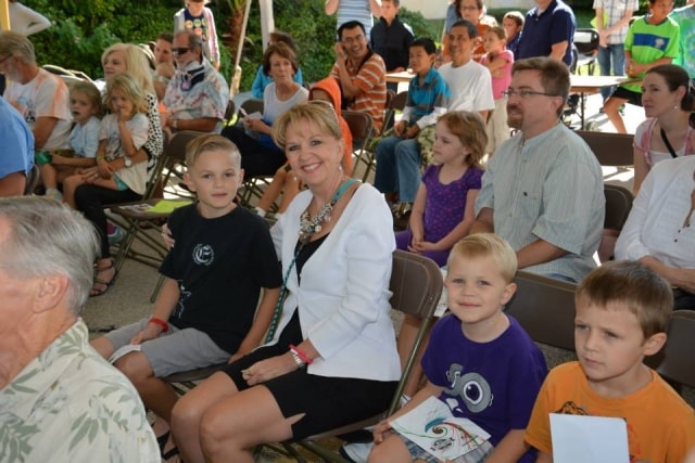 Audience seated outdoors at CreekFest Houston main stage performance